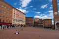 SIENA, ITALY Ã¢â¬â MAY 25, 2017: Campo Square Piazza del Campo, Palazzo Pubblico and Mangia Tower Torre del Mangia. Royalty Free Stock Photo